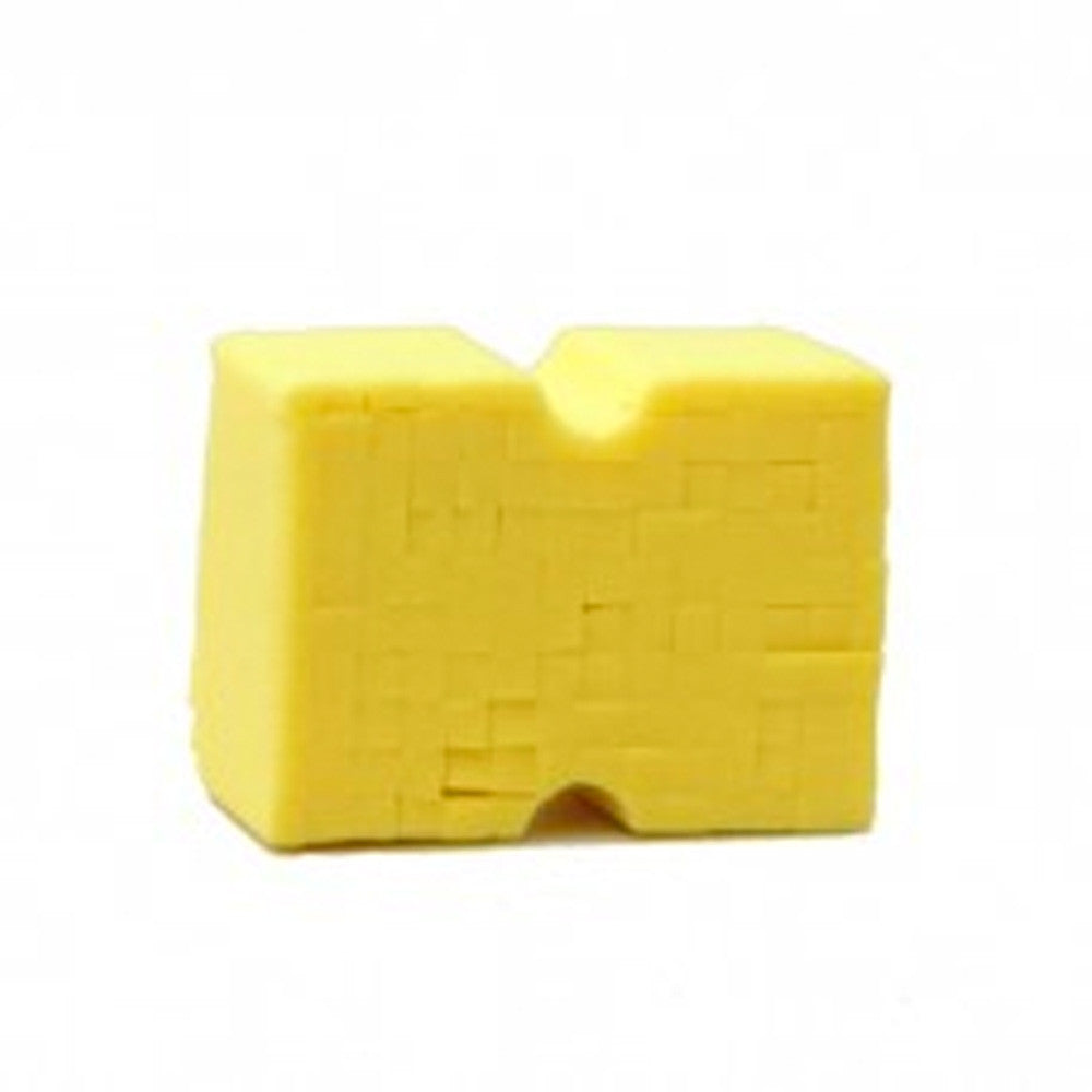 A bright yellow textured block featuring a prominent U-shaped groove on its top surface and a subtle curved cutout on the bottom front edge